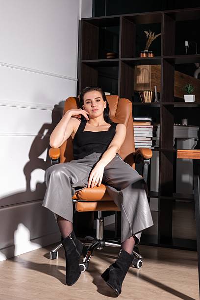 istock Young woman posing confidently in modern office setting during afternoon light 2219546181