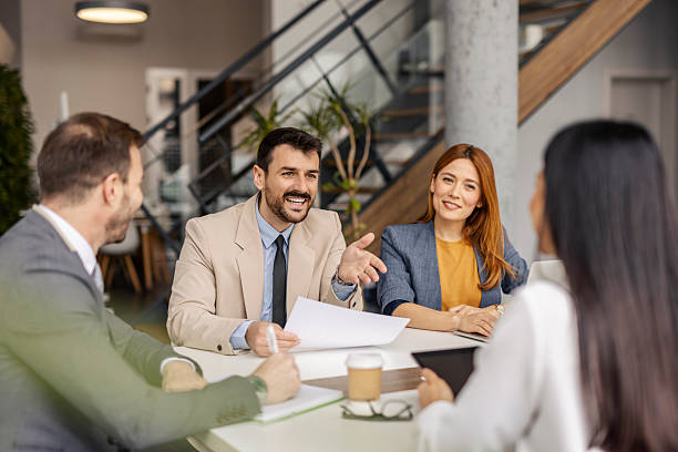istock Leadership team sitting at corporate office at conference table and discussing case study. 2219547954