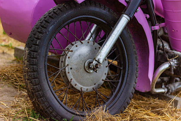 Security number padlock blocking motorcycle wheel on the street.