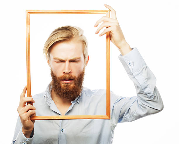 istock Young man holding picture frame 2219549691