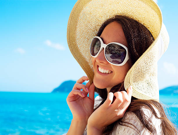 istock Happy woman in hat on the beach 2219549759