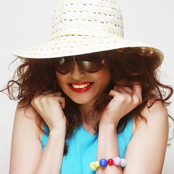 istock young surprised woman wearing hat and sunglasses 2219550844