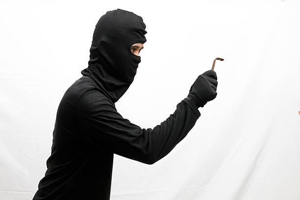 istock Thief breaking into money storage with small pliers, isolated on white background 2219551929