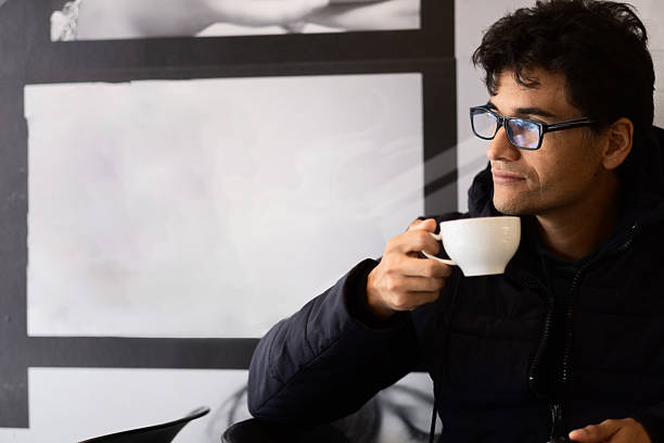stylish man drinking coffee in the street