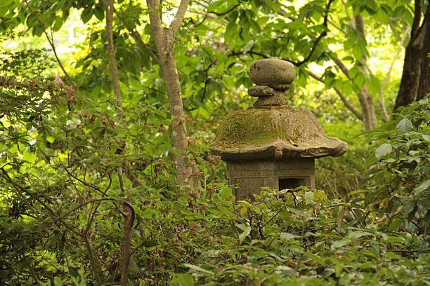 A beautifully manicured Japanese garden near Arashiyama blends refined landscaping with the natural atmosphere of a forest. Stone pathways wind through moss-covered grounds, under the shade of sculpted pines, maples, and bamboo groves. The garden offers a quiet retreat from the city, where visitors can experience harmony between human craftsmanship and the surrounding woodland. Gentle light filters through the trees, creating a serene and meditative space rich in seasonal beauty.
