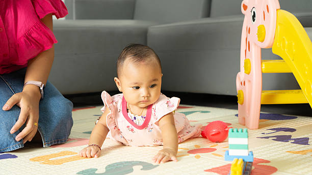istock Baby Playing on Floor with Mom Nearby 2219555061