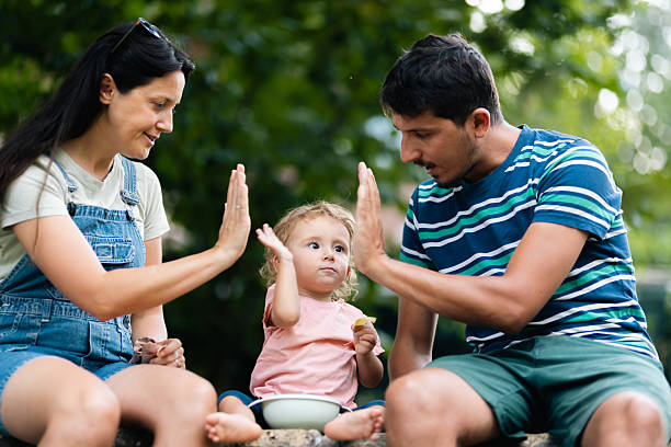 istock Happy family bonding outdoors with a child during summertime 2219556460
