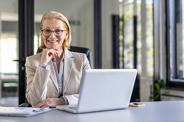 istock Cheerful female executive posing with a laptop confidently 2219556646