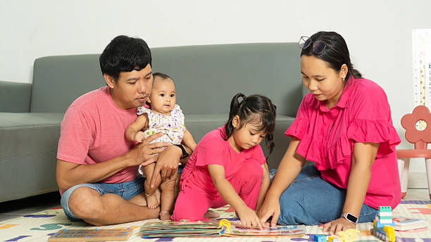 istock Whole Family Playing with Toy Blocks on Mat 2219556751