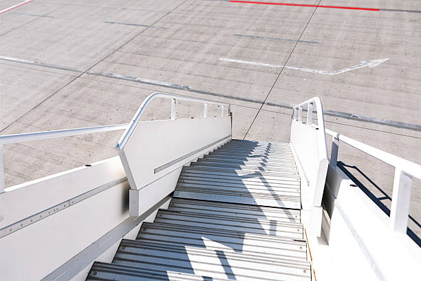 A stairs are ready under the open rear door of the aircraft, after landing.