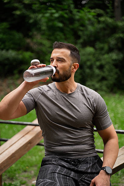 istock Closeup shot of handsome man drinking water after workout 2219562818