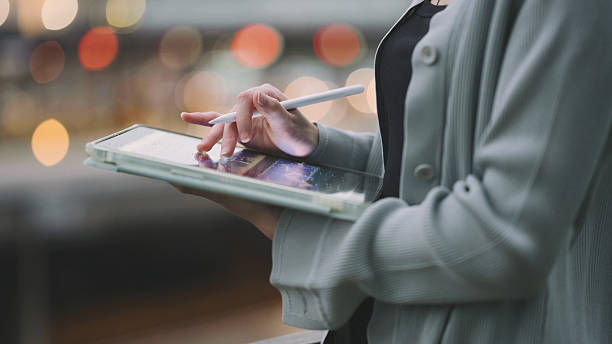 istock person reviewing multiple digital graphs and stock indicators on smart tablet analyzing real-time trading data and financial analytics using tablet device in technology-driven investment environment 2219562991