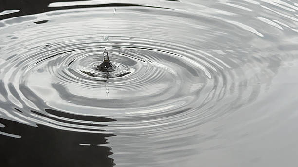 istock A droplet falling into an open-air bath, creating beautiful ripples on the water's surface 2219564416