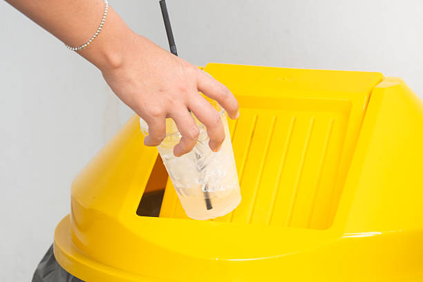 istock Please throw plastic cup in the bin. Man littering the bins by separating waste for disposal such as recyclable plastic waste. environmental concept 2219570905