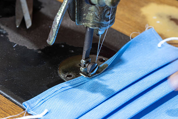 istock A making face masks from sterilization wrapping paper on a sewing machine. A homemade produce of masks to protect against dirt, smog and virus, close up. 2219572247
