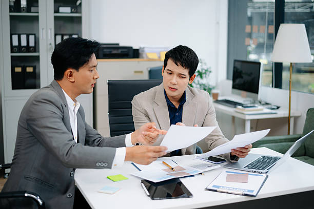 istock Furious two Asian businesspeople arguing strongly after making a mistake at work in office. 2219573545