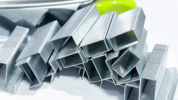 Close-up of Silver Staples on White Background
