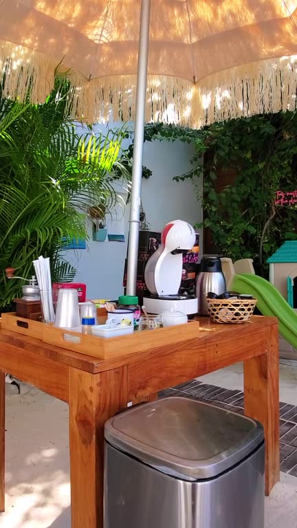 Coffee time. Table set with modern capsule coffee machine with accessories