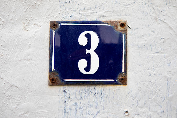 istock Number 3 on a rough white plaster wall 2219581650