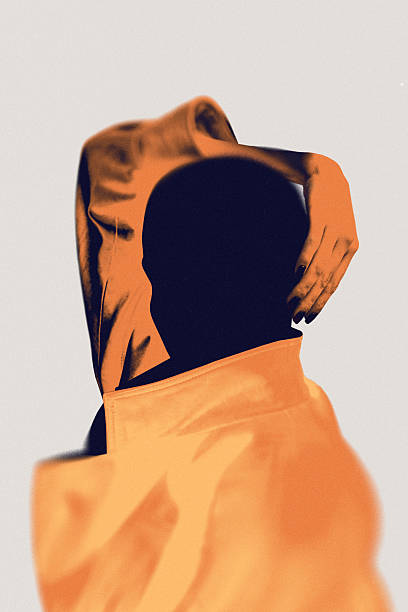 istock Abstract orange-toned figure on orange clothes isolated on neutral background. 2219594221