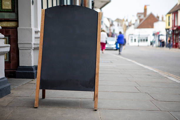 istock A-frame chalkboard sign on a town pavement with copy space 2219595020