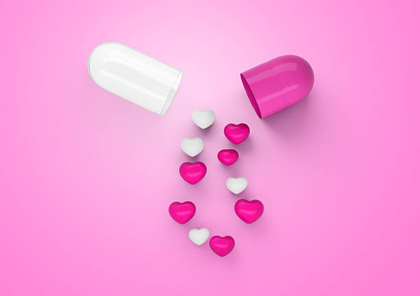 istock An Open Pink And White Glossy Capsule With Minimal Heart Shaped Pills Spilling Out 3D Illustration 2219596108