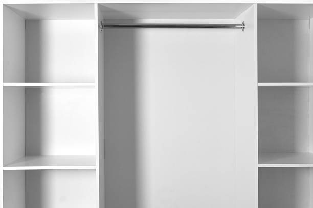 Minimalist empty white wardrobe with shelves and a metal clothes rail. Clean, modern and ready for organization.