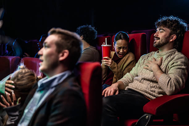 istock Spectators react to a thrilling scene in a movie theater 2219604854