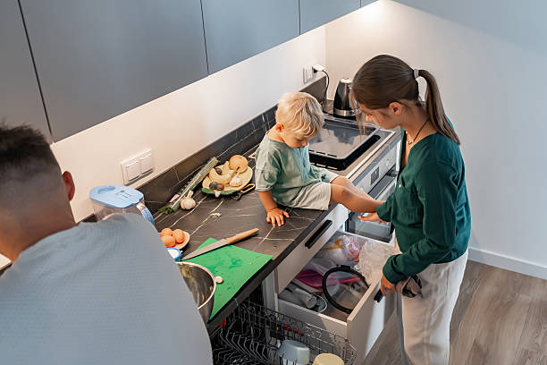 istock Family Together in Modern Kitchen Looking into Drawer 2219607527