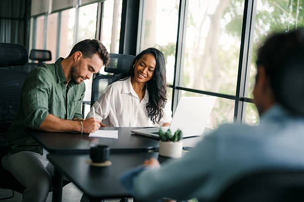 istock Group of young multi-ethnic startup business team collaborating on project in modern office 2219610394