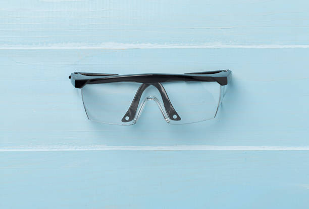 Transparent plastic safety goggles with a black elastic strap to secure the goggles to ones head.