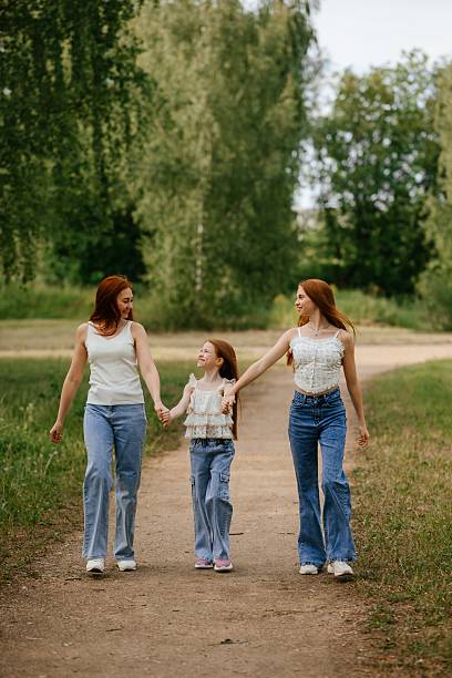 istock Mother and Daughter Holding Hands on a Nature Walk 2219611366