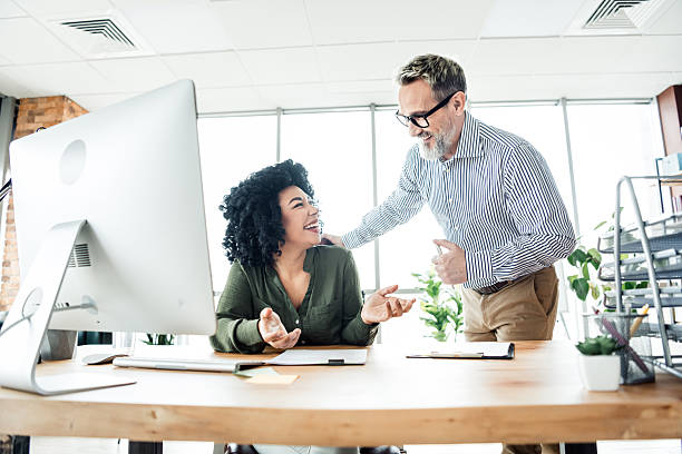 istock Professional coworkers engaging in a collaborative team meeting within a bright office environment 2219613302