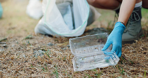 istock Person, hands and plastic with bag for recycling, climate change or global warming in nature. Closeup, volunteer or community service with dirt, garbage or container for cleaning litter or earth day 2219614729