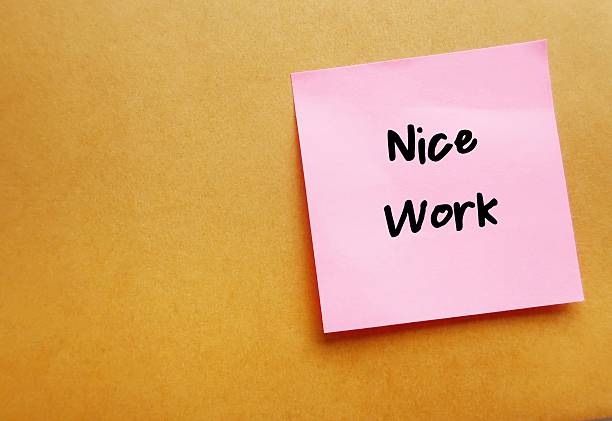 istock Office envelope with compliment note NICE WORK - giving positive feedback in response to a job well done - compliment from manager boss to team member employee - praise from teacher to student who did a good work 2219615225
