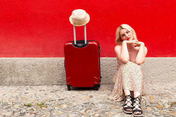 Arrive to new place. Woman waving hand to catch taxi at airport terminal, copy space