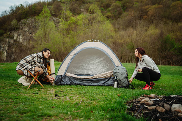 istock Two female friends or sisters setting up camp 2219616306
