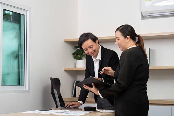 istock Professional Collaboration in Financial Analysis. Colleagues reviewing reports in a modern office. 2219617488