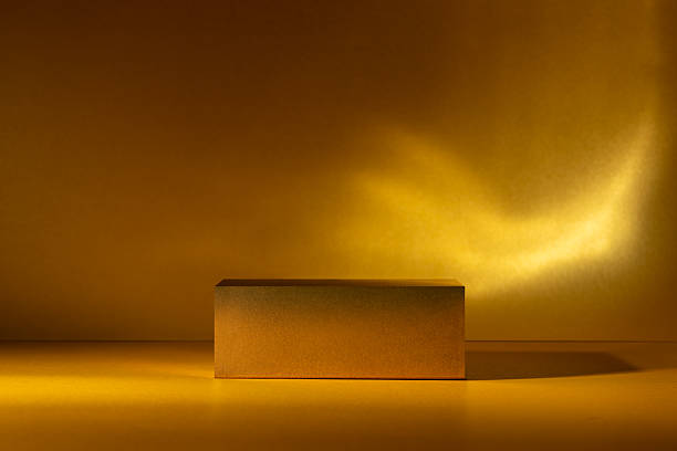 istock Golden podium on a vibrant golden surface with dramatic studio lighting 2219619665