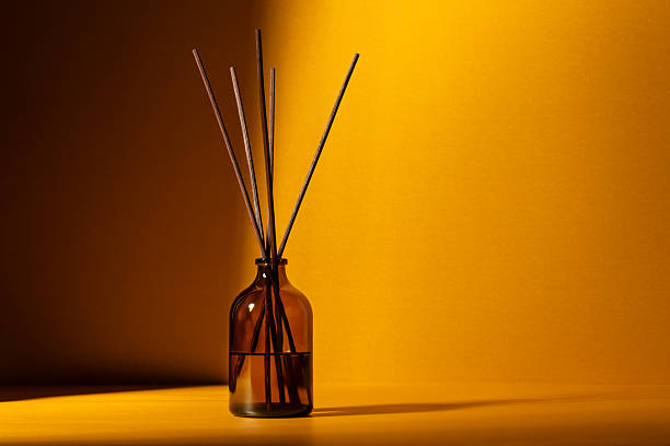 istock Amber glass diffuser bottle with fragrance sticks 2219619786