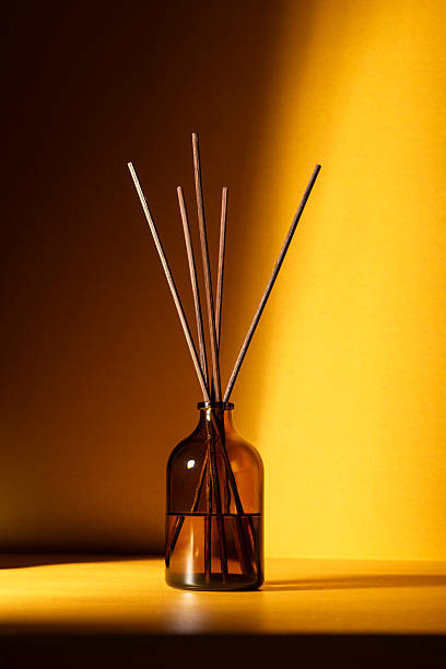 istock Amber glass diffuser bottle with fragrance sticks 2219619800