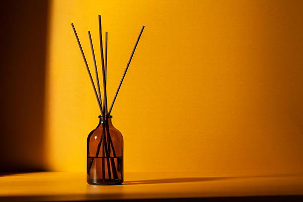 istock Amber glass diffuser bottle with fragrance sticks 2219619840