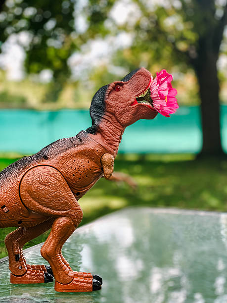 Toy Dinosaur Holding A Flower In Its Mouth