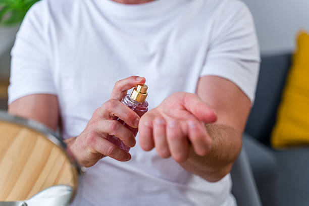 istock Man spraying perfume on his wrist 2219621688