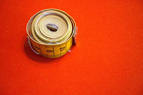 Measuring tape with orange background.