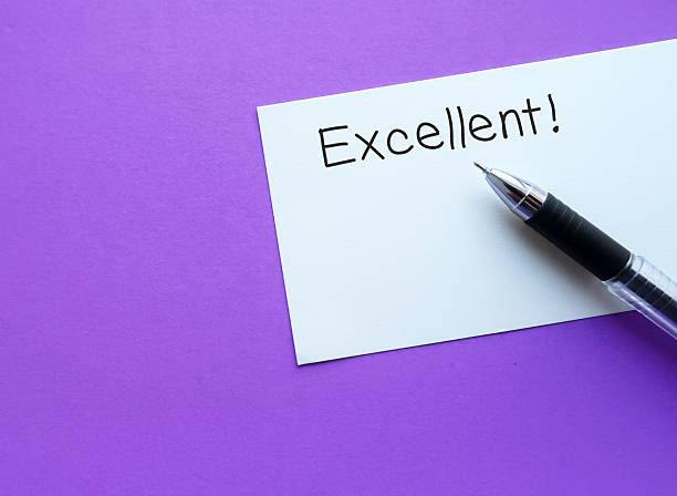 istock Compliment note on purple background EXCELLENT  - giving positive feedback in response to a job well done - compliment from manager boss to employee - praise from teacher to student who did good job 2219622239