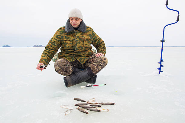 istock man on winter fishing 2219624212
