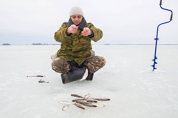 istock man on winter fishing 2219624218