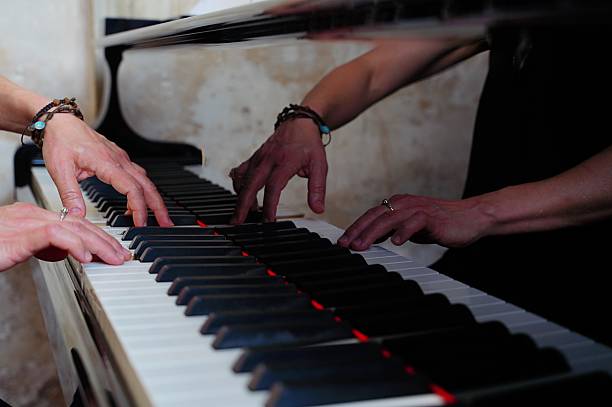 istock Woman Playing Piano with Reflective Surface 2219627528