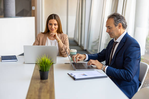 istock Businesspeople working on laptops in modern office 2219628443